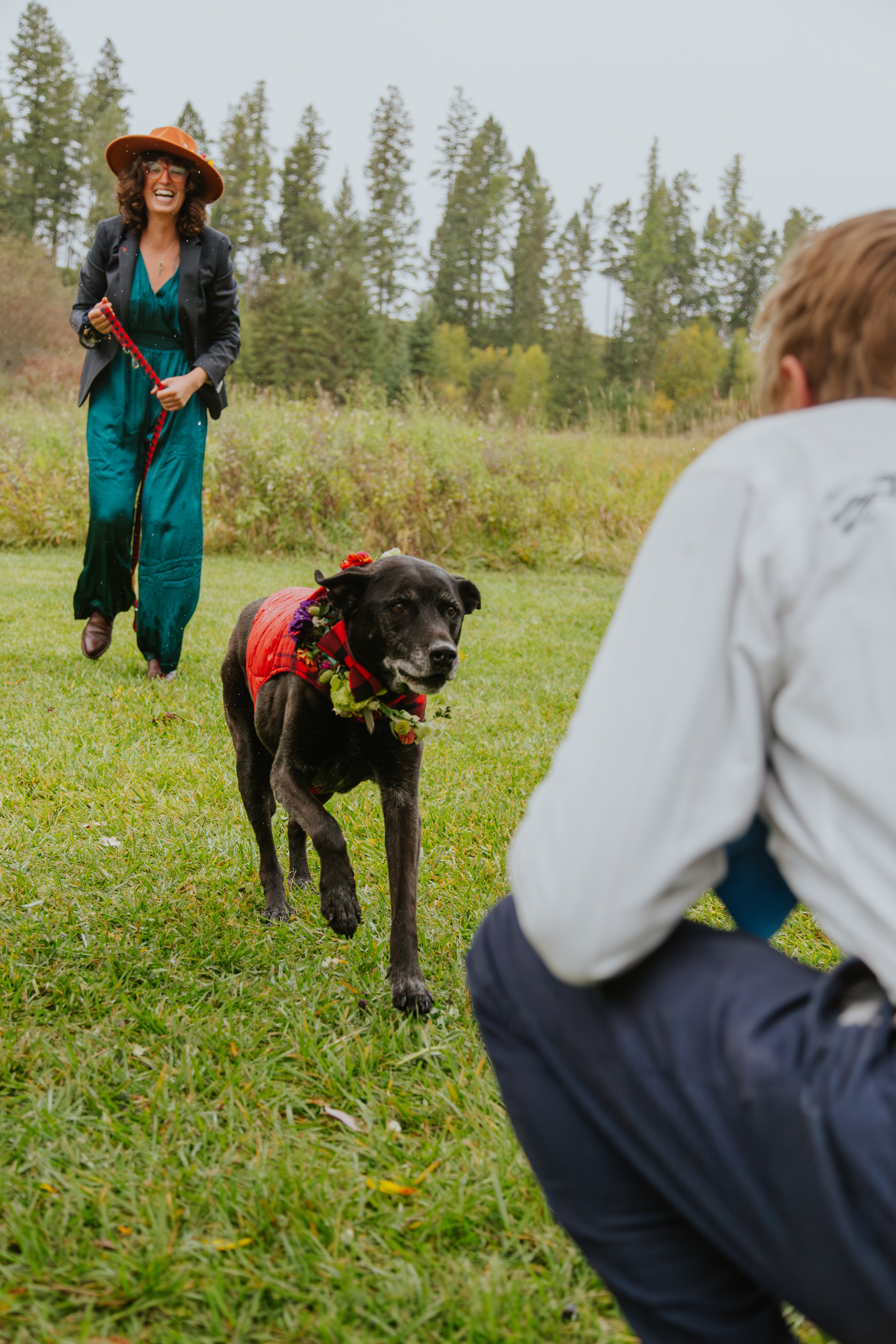Andy and Porter walk joyfully toward their partner Devin on their wedding day.